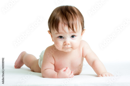 Photo: baby boy lying on tummy isolated on white background baby boy lying on tummy isolated on white background