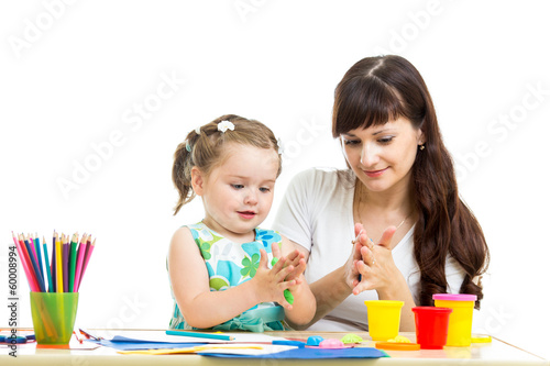 Photo: kid girl and mother play colorful clay toy kid girl and mother play colorful clay toy
