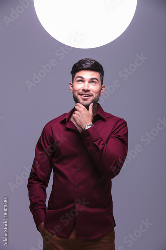 Photo: smiling casual man looking into a big ball of light smiling casual man looking into a big ball of light