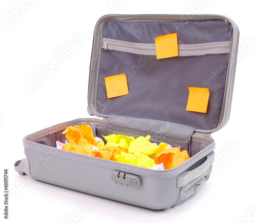 Photo: Open suitcase with paper stickers isolated on white Open suitcase with paper stickers isolated on white