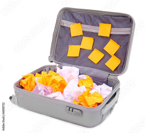 Photo: Open suitcase with paper stickers isolated on white Open suitcase with paper stickers isolated on white