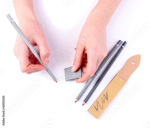Photo: Hands with pencils and erase isolated on white Hands with pencils and erase isolated on white