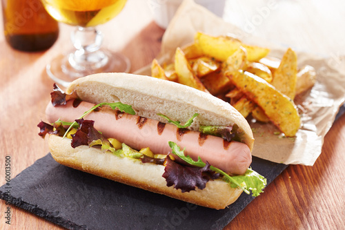 Photo: Gourmet hot dog on slate board Gourmet hot dog on slate board