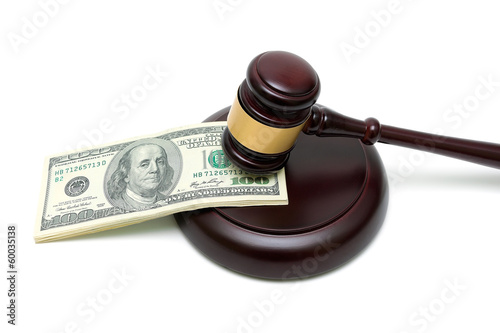 Photo: money and gavel on white background close up money and gavel on white background close up