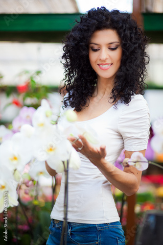 Photo: Beautiful woman in a green house Beautiful woman in a green house