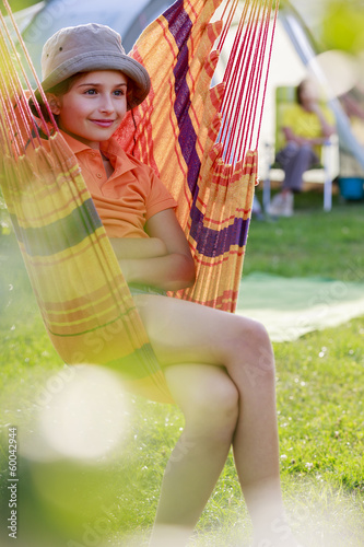 Photo: Summer camp - young girl with family on the camping Summer camp - young girl with family on the camping