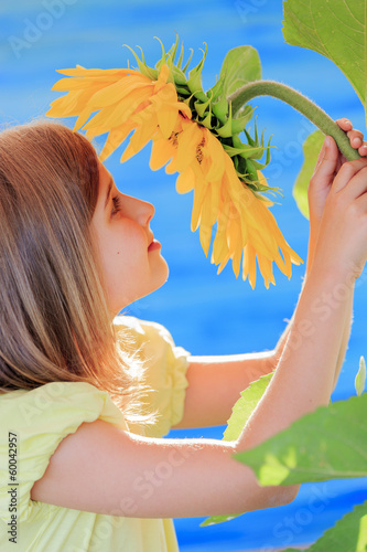 Photo: Girl and sunflower - girl is smelling sunflower Girl and sunflower - girl is smelling sunflower