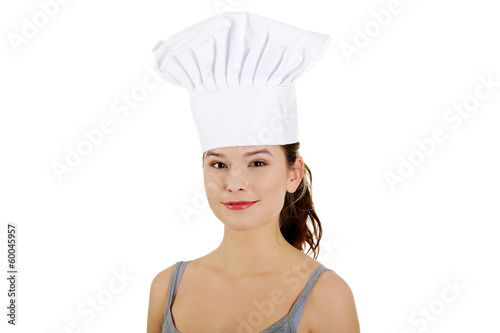 Photo: Young woman with chef hat. Young woman with chef hat.