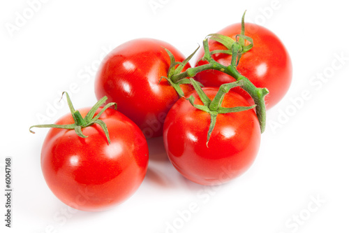 Photo: three fresh tomatoes with green leaves isolated on white backgro three fresh tomatoes with green leaves isolated on white backgro