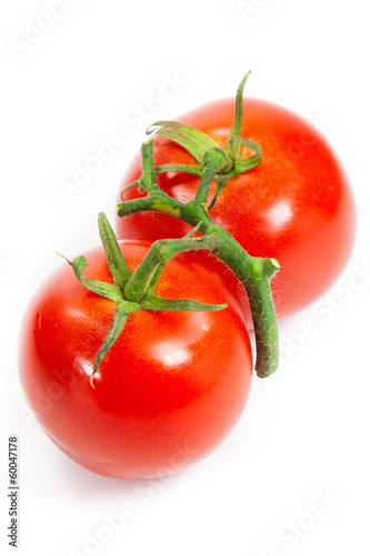 Photo: three fresh tomatoes with green leaves isolated on white backgro three fresh tomatoes with green leaves isolated on white backgro