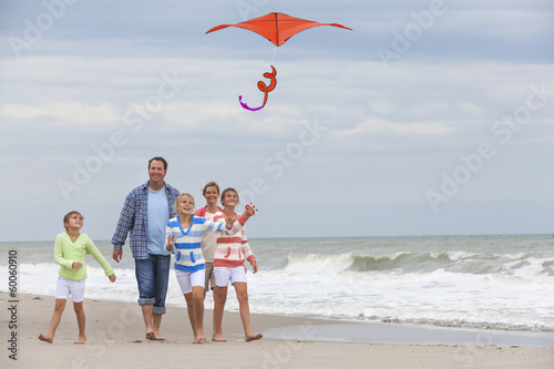 Photo: Family Parents Girl Children Flying Kite on Beach Family Parents Girl Children Flying Kite on Beach
