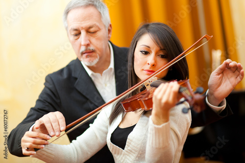 Photo: Man teaching to play viola Man teaching to play viola