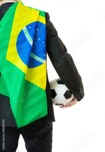Photo: Asian business man holding soccer ball with Brazil flag Asian business man holding soccer ball with Brazil flag