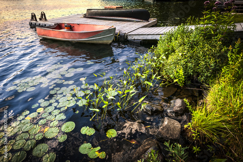 Photo: Rowboat at lake shore at dusk Rowboat at lake shore at dusk