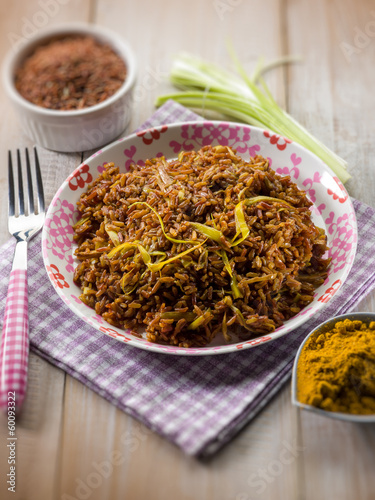 Photo: red rice with curry and leek, selective focus red rice with curry and leek, selective focus