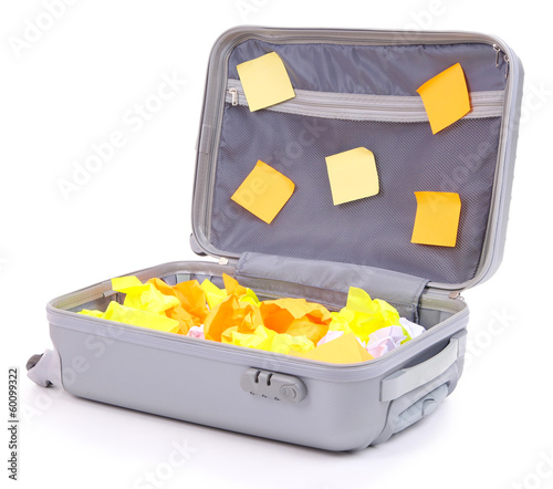 Photo: Open suitcase with paper stickers isolated on white Open suitcase with paper stickers isolated on white