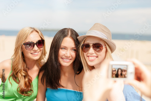 Photo: girls taking photo with digital camera in cafe girls taking photo with digital camera in cafe