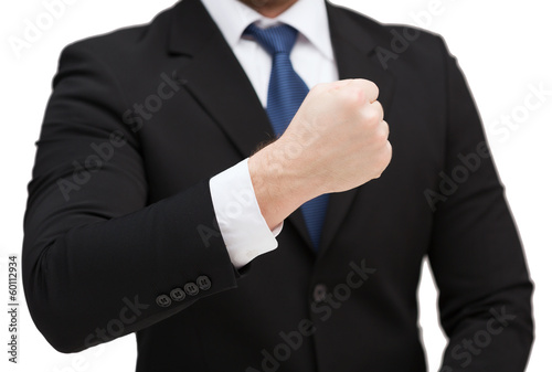 Photo: businessman showing something at his hand businessman showing something at his hand