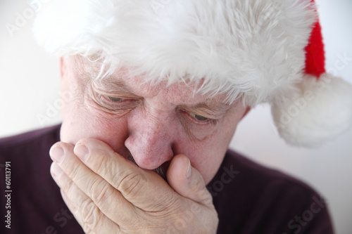 Photo: senior in Santa hat has nausea senior in Santa hat has nausea