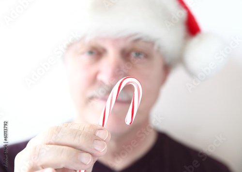 Photo: older man with candy cane older man with candy cane