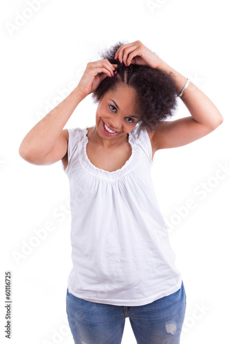 Photo: Young african american woman making braids Young african american woman making braids