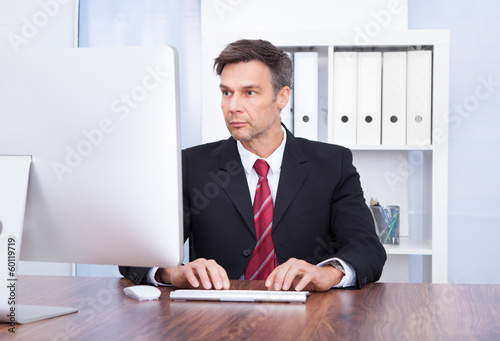 Photo: Businessman Using Computer Businessman Using Computer