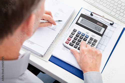 Photo: Businessman Calculating Finance Businessman Calculating Finance