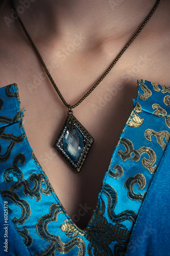 Photo: amulet on a neck at sorceress closeup amulet on a neck at sorceress closeup