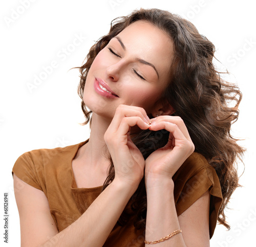 Photo: Woman in love showing Heart with her Hands. St. Valentine's Day Woman in love showing Heart with her Hands. St. Valentine's Day