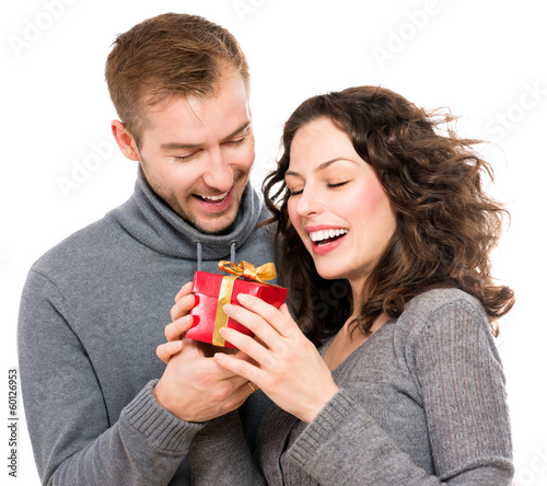 Photo: Valentine Gift. Happy Young Couple with Valentine's Day Present Valentine Gift. Happy Young Couple with Valentine's Day Present