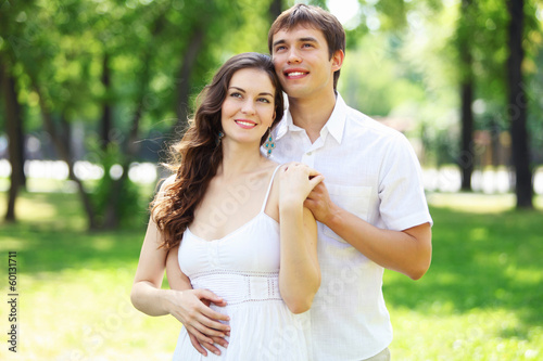 Photo: Young love Couple smiling under blue sky Young love Couple smiling under blue sky