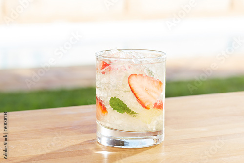 Photo: Strawberry mojito cocktail by a pool outdoors Strawberry mojito cocktail by a pool outdoors