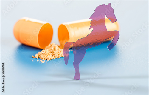Photo: vitamins in capsules and toy horse vitamins in capsules and toy horse