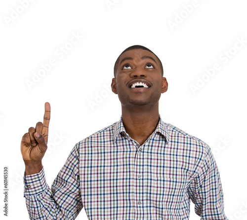 Photo: Excited young man pointing up, having a solution Excited young man pointing up, having a solution