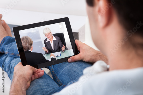 Photo: Young Man Watching Movie On Tablet Pc Young Man Watching Movie On Tablet Pc