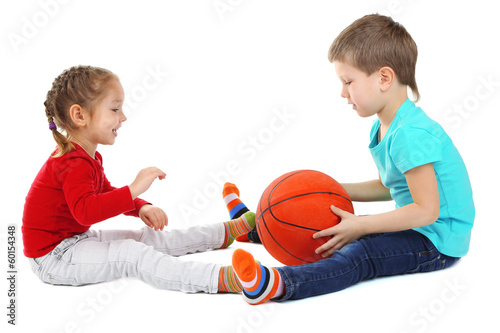Photo: Little children playing with ball isolated on white Little children playing with ball isolated on white