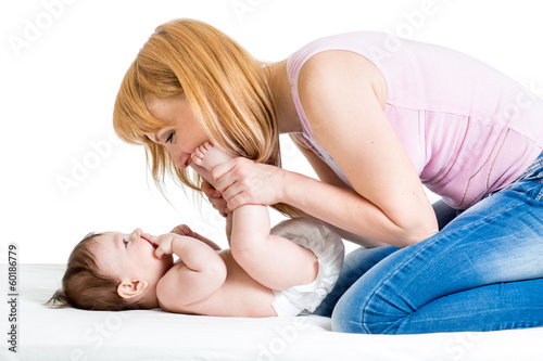 Photo: joyful mother playing with her baby infant joyful mother playing with her baby infant