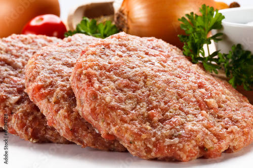 Photo: Raw minced pork chops meat on white background Raw minced pork chops meat on white background