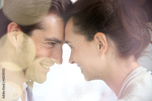 Photo: Profile of loving couple looking at each other Profile of loving couple looking at each other