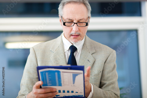 Photo: Businessman reading some documents Businessman reading some documents