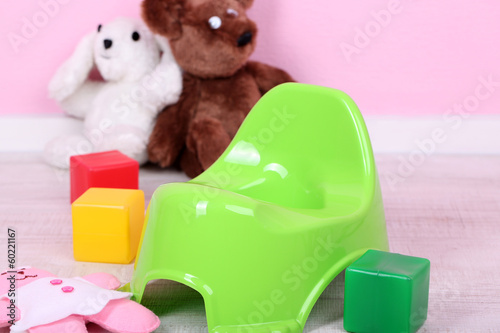 Photo: Green potty on home interior background Green potty on home interior background