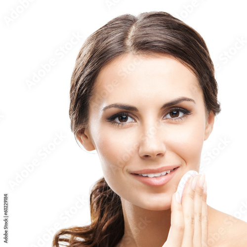 Photo: Young woman cleaning skin by cotton pad Young woman cleaning skin by cotton pad