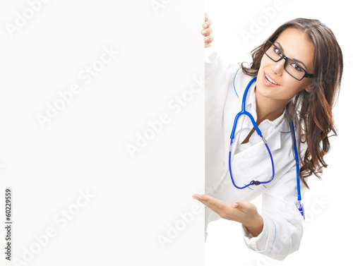 Photo: Doctor showing blank signboard, isolated Doctor showing blank signboard, isolated