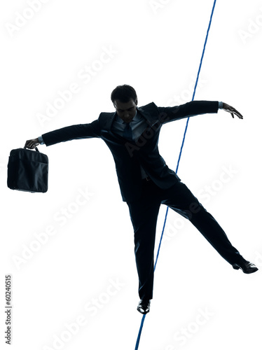 Photo: Businessman tightrope walker silhouette Businessman tightrope walker silhouette