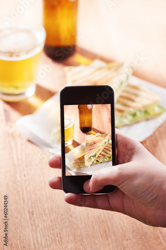 Photo: Smartphone taking photo of feta cheese sandwich Smartphone taking photo of feta cheese sandwich