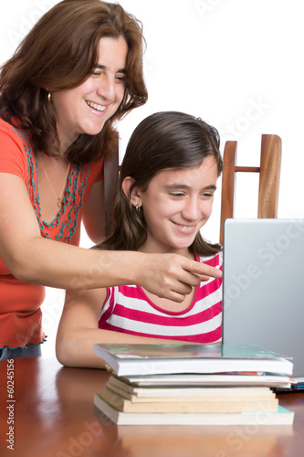 Photo: Hispanic teen and her mother browsing the web and laughing Hispanic teen and her mother browsing the web and laughing