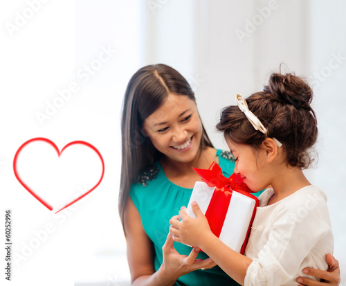Photo: happy mother and child girl with gift box happy mother and child girl with gift box