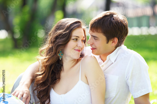 Photo: Young love Couple smiling under blue sky Young love Couple smiling under blue sky