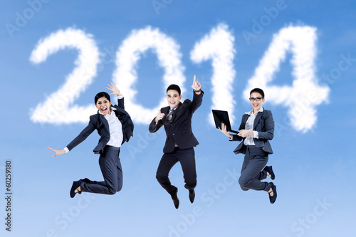 Photo: Excited businesspeople jumping on the sky Excited businesspeople jumping on the sky