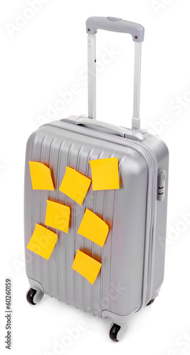 Photo: Suitcase with paper stickers isolated on white Suitcase with paper stickers isolated on white